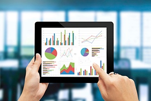 Using a tablet to review
workers' compensation data analytics information.